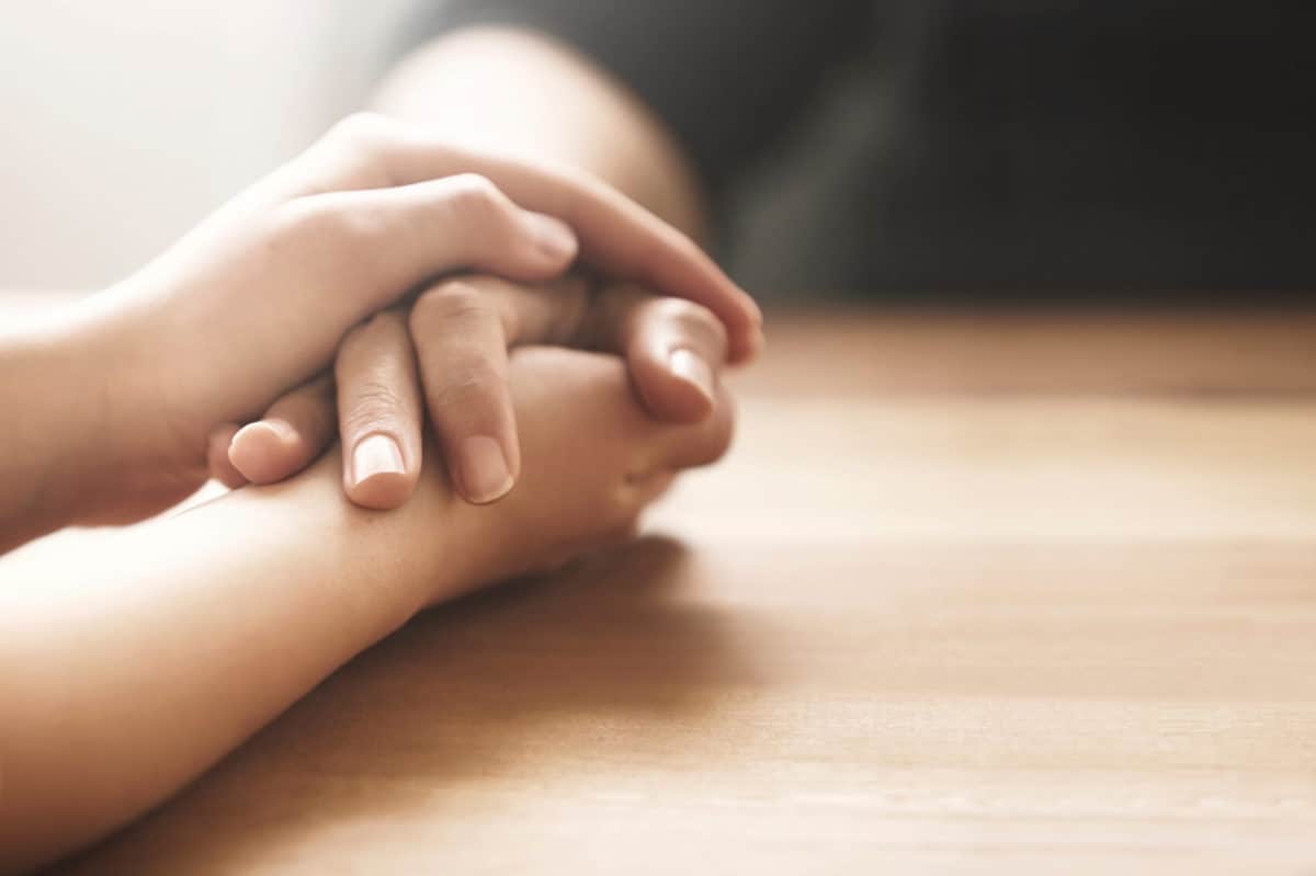Friends holding hands