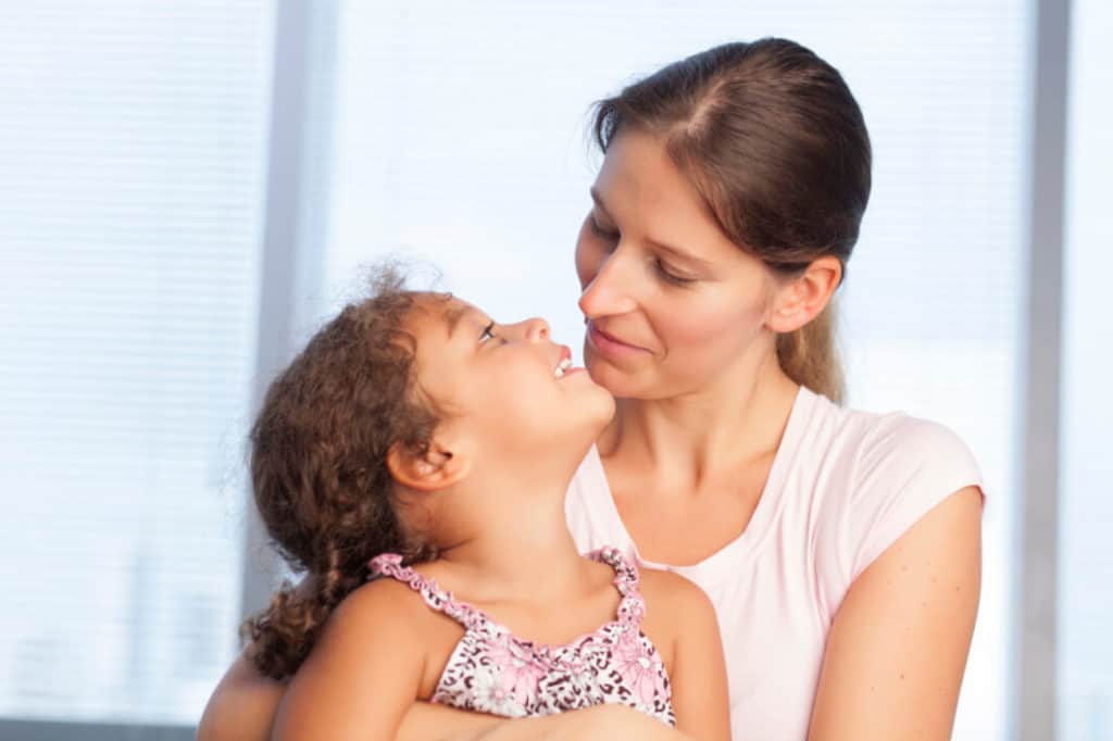 Mother and daughter smiling at each other