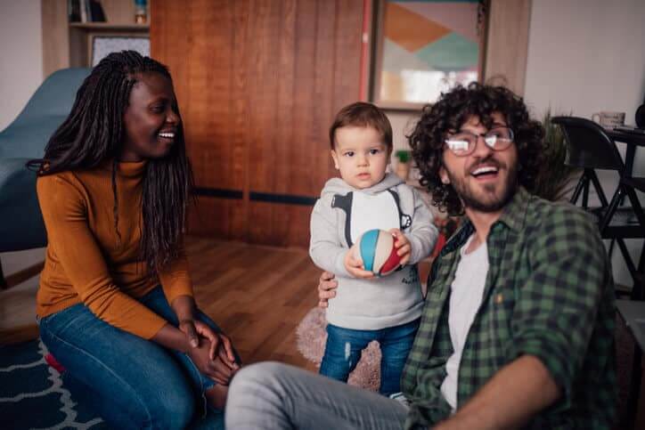 Foster parents playing with baby