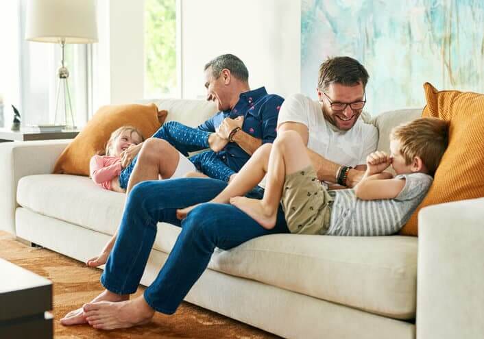 Full length shot of an affectionate family of four on the sofa at home